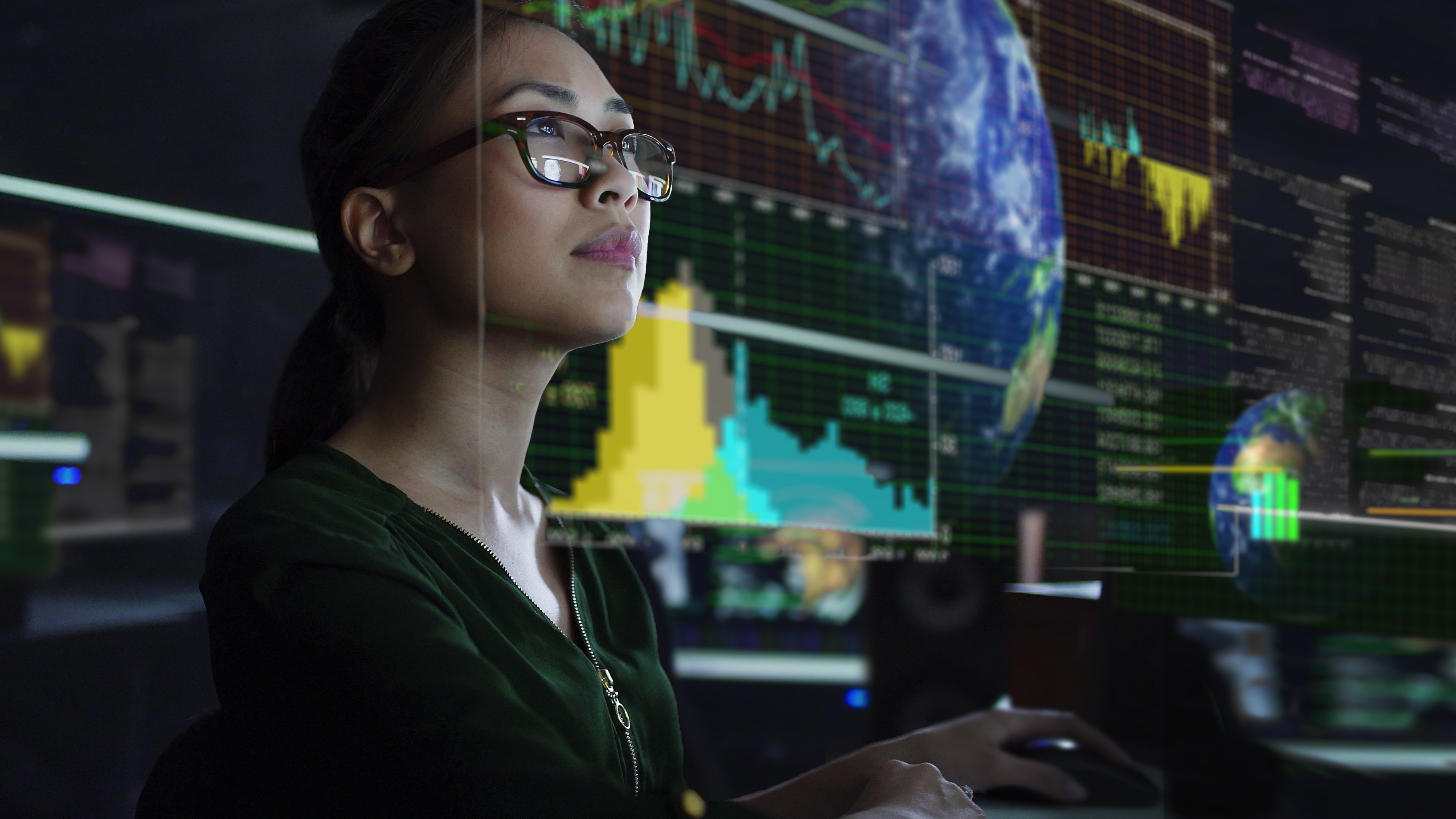 Person looking at a screen with data and world as content. Source: Getty Images