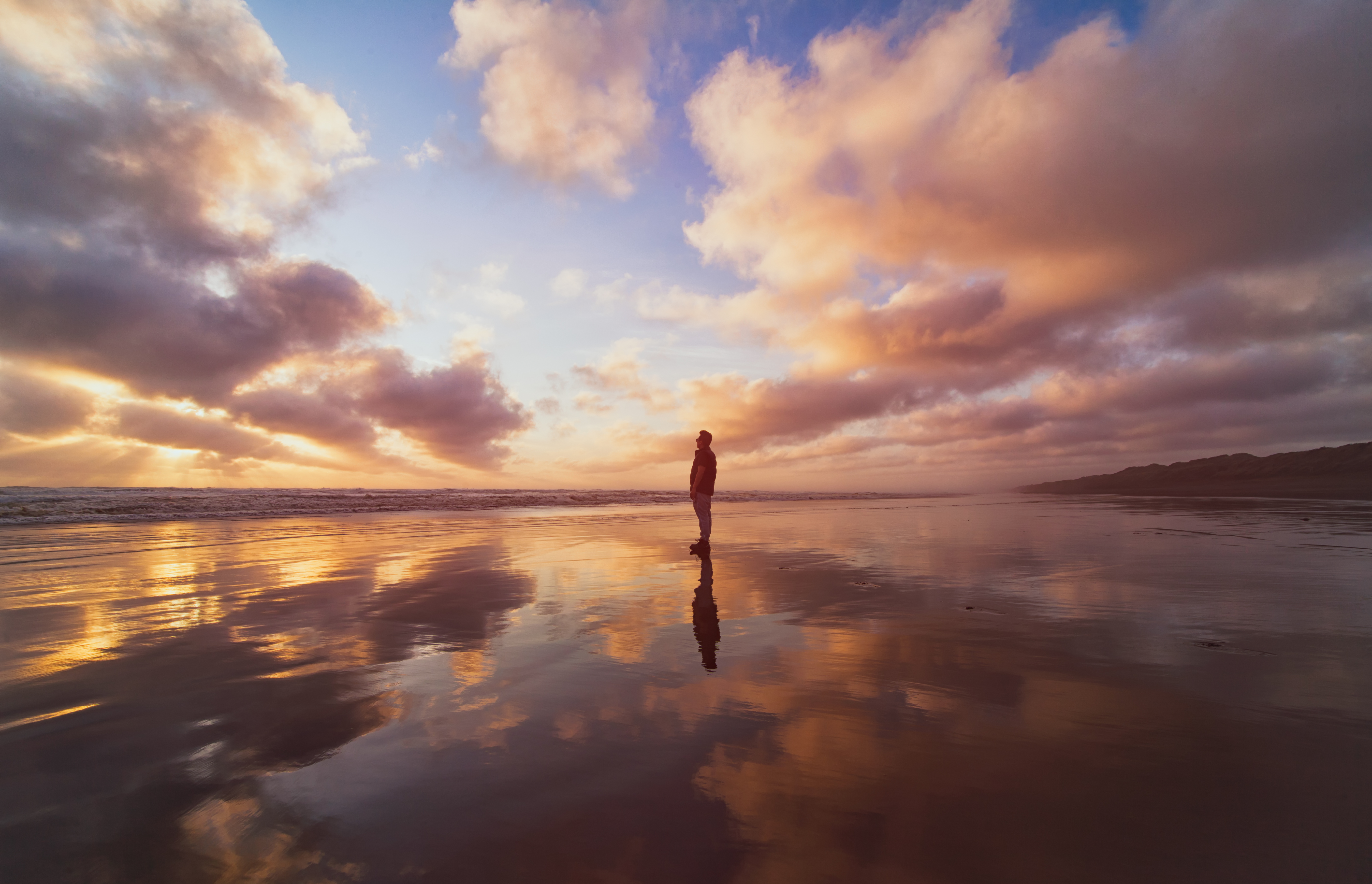 Person on the beach contemplating the sky