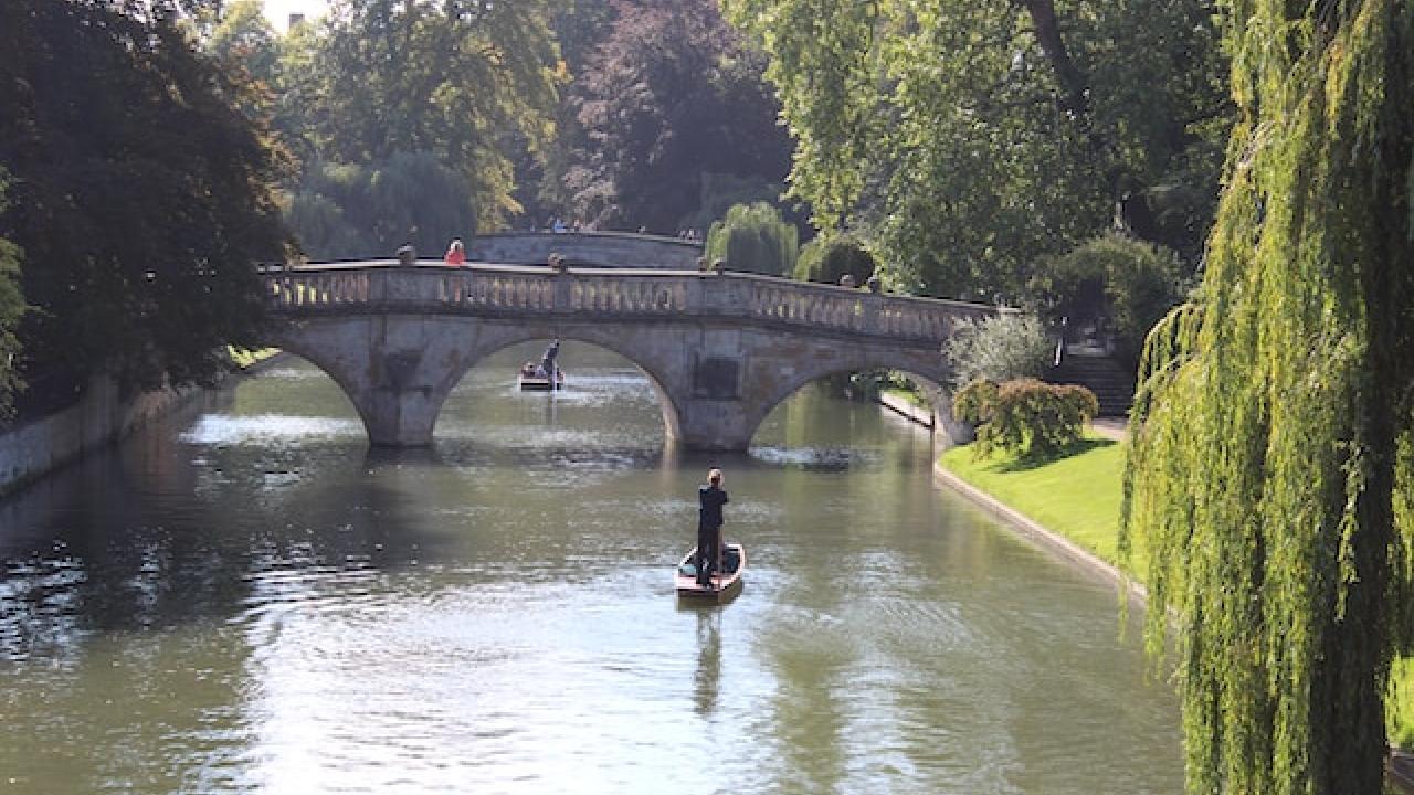 Photo by Karen Cann on Unsplash. Punting by the river Cam