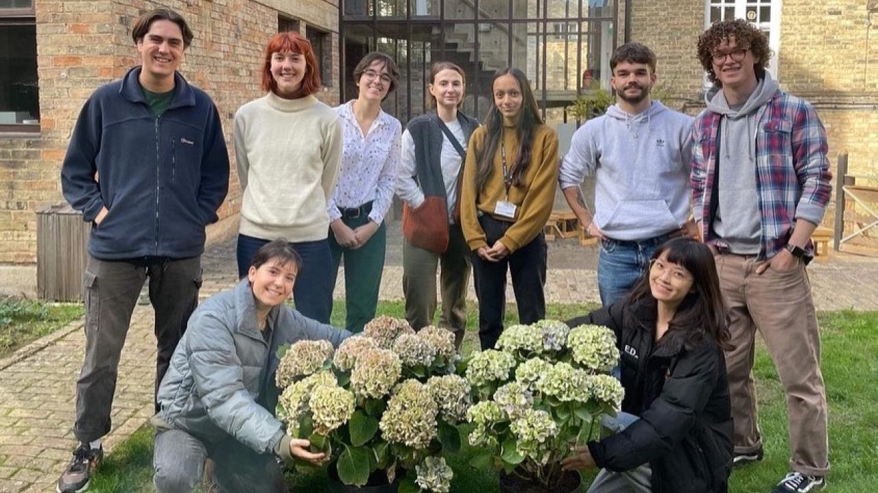 Arcsoc garden committee in front of Architecture Department with plants