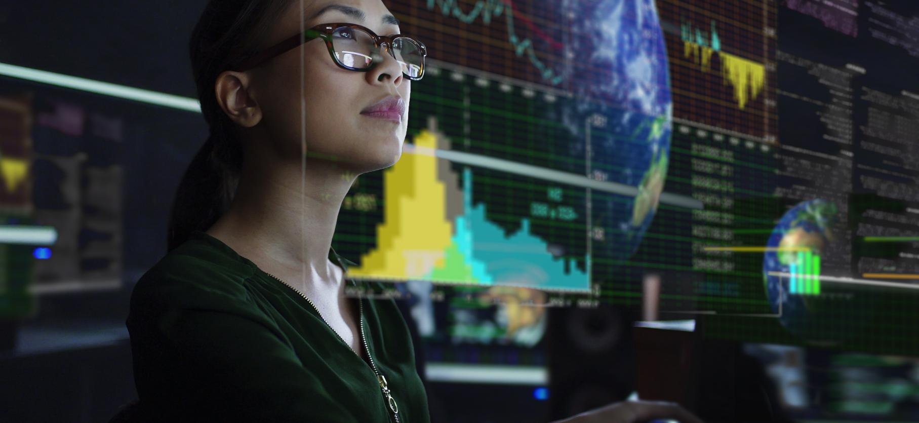 Person looking at a screen with data and world as content. Source: Getty Images