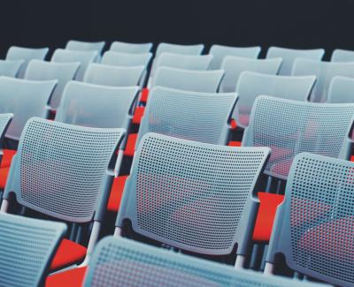 Row of white chairs. Photo by ål nik on Unsplash
