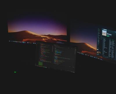 Computer monitors with data on them. Photo by David Schultz on Unsplash